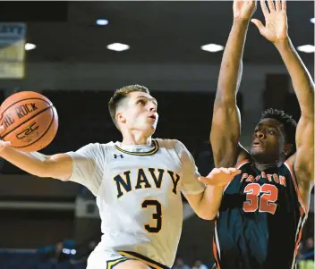  ?? TERRANCE WILLIAMS/AP ?? Navy guard Sean Yoder goes to the basket against Princeton forward Keeshawn Kellman to attempt a layup during the second half of Friday night’s game at the Veterans Classic in Annapolis.