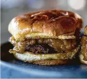  ?? Kirsten Gilliam ?? Louie’s/Riel’s Butter Burger with cheese and caramelize­d onions