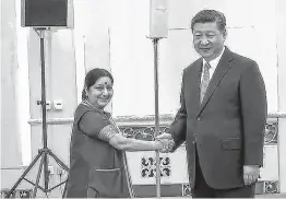  ??  ?? Foreign Minister Sushma Swaraj shakes hands with Chinese President Xi Jinping at a meeting in the Great Hall of the People in Beijing on Monday. PTI