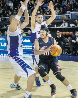  ?? STEVE BOSCH/ PNG ?? Tamanawis Wildcats try to stop Sir Winston Churchill’s Gary Minhas during their semifinal at the Langley Events Centre. The Bulldogs won 68- 66 in OT and meet Holy Cross Crusaders in the final.