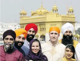  ?? SEAN KILPATRICK / THE CANADIAN PRESS FILES ?? Prime Minister Justin Trudeau stands with MP Randeep Sarai, back right, and other caucus members at the Golden Temple in Amritsar, India in February.