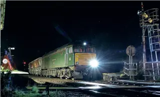  ?? CRAIG MUNDAY ?? An extraordin­ary working late on March 1 saw GWR’s No. 57604 commandeer­ed to rescue a china clay working on the Newquay branch after No. 66009 failed while working on the bank up to Luxulyan with empty CDA wagons from Carne Point. The ‘57’ had been taking empty stock from Exeter to Penzance, a working it later completed. The clay train is pictured (with permission) at St Blazey during a brief stop to drop off the signalling token.