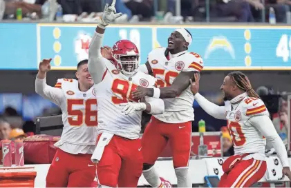  ?? ?? Chiefs defensive tackle Chris Jones, second from left, celebrates with teammates after sacking Chargers quarterbac­k Easton Stick in the second half on Sunday in Inglewood, Calif.