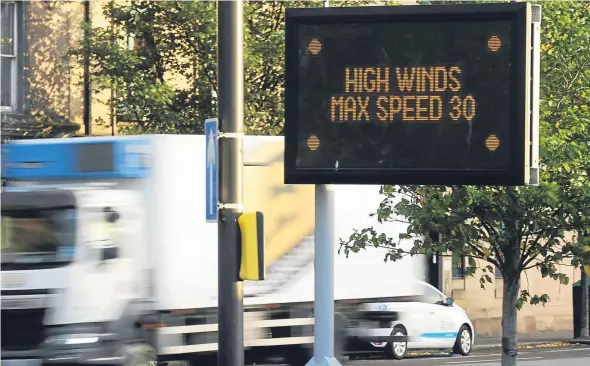  ??  ?? Signs near the Tay Road Bridge today warning drivers that there were restrictio­ns in place due to the weather.