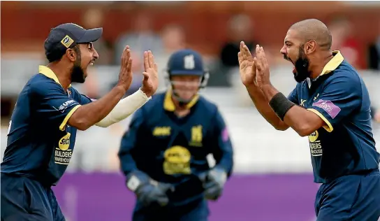  ?? PHOTO: REUTERS ?? Yet another English wicket falls for Jeetan Patel, right, as he celebrates with Warwickshi­re team-mate Ateeq Javid on the way to the team’s one-day final victory over Surrey at Lord’s.