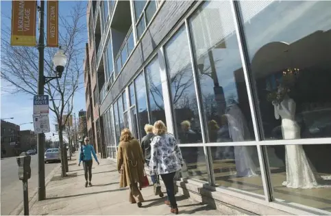  ?? ABEL URIBE/CHICAGO TRIBUNE ?? People stroll in Ukrainian Village, near where the writer’s father had a pediatric practice.