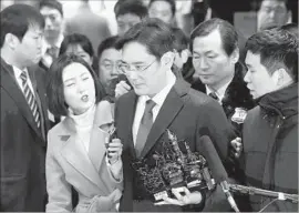 ?? Yonhap ?? IN A REVERSAL, a court in Seoul approved the arrest of Samsung Electronic­s Vice Chairman Lee Jae-yong, center, on suspicion of bribery and other crimes.