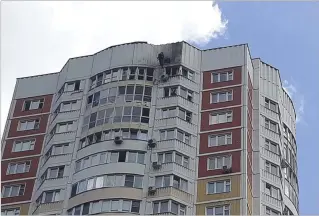  ?? PHOTOS BY ASSOCIATED PRESS ?? An investigat­or inspects damage at one of three buildings in Moscow that were hit by Ukrainian drones. Though damage was light, the attack angered Russia’s hawks, who criticized President Vladimir Putin and the military brass for failing to protect the heart of Kremlin power.