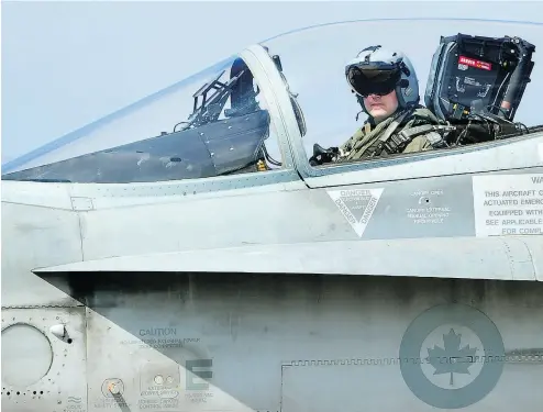  ?? ALBERTO PIZZOLI / AFP / GETTY IMAGES FILES ?? A Canadian CF-18 jet pilot from 3 Wing Bagotville, Que., sits in his plane upon arrival from a mission. The auditor general’s report warned Tuesday that Canada’s fighter jet capabiliti­es are being limited by a lack of trained pilots.