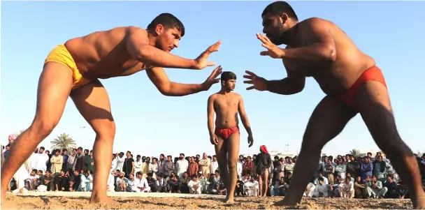  ??  ?? Pakistani immigrant workers in the United Arab Emirates take part in a Kushti competitio­n in Dubai. Kushti is popular in India, Pakistan and Bangladesh and was developed in the Mughal era by combining native ‘mallayuddh­a’ wrestling with Persian ‘pahlavani’. — AFP photos