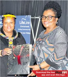  ?? ?? Download the free app and scan this logo.
LifeLine’s Victim Empowermen­t Programme manager, Nompilo Maphumulo presents a token of appreciati­on to guest speaker, BWA chairperso­n Jabu Dlamini for her inspiring address