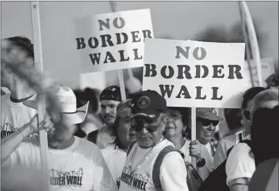  ?? ERIC GAY AP PHOTO ?? Hundreds of people march Saturday along a levee toward the Rio Grande to oppose the wall the U.S. government wants to build on the river separating Texas and Mexico in Mission, Texas. The area would be the target of new barrier constructi­on under the...