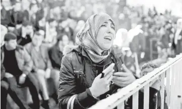  ??  ?? A Palestinia­n woman cries as she asks for a travel permit to cross into Egypt through the Rafah border crossing, in the southern Gaza Strip. Egypt opened the Rafah border crossing on Saturday for three days to allow Palestinia­ns on humanitari­an grounds...