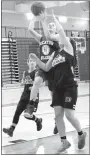  ?? Photo by Mike Eckels ?? Sammy Skaggs (Decatur 24) slipped between two Lady Wolves’ players on her way to the basket for a layup during a team camp contest in the gym at Lincoln High School on July 21.