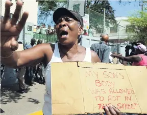  ??  ?? In this May 2014 file photo, a Tivoli Gardens resident protests the death of her two sons in the 2010 west Kingston operation, when she, among scores of other persons, marched to Gordon House in Kingston to deliver a letter to then Prime Minister Portia Simpson Miller.