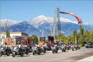  ?? Photograph­s by Gina Ferazzi Los Angeles Times ?? RIVERSIDE COUNTY sheriff ’s deputies lead the funeral procession for Deputy Darnell Calhoun on Saturday. Calhoun’s death was the second killing of a Riverside County deputy in recent weeks.