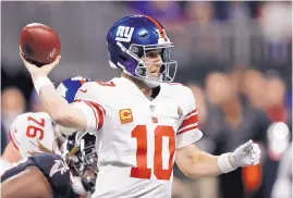  ?? JOHN BAZEMORE/ASSOCIATED PRESS ?? New York Giants quarterbac­k Eli Manning throws the ball against the Atlanta Falcons defense during the first half of a game Oct. 22 in Atlanta.