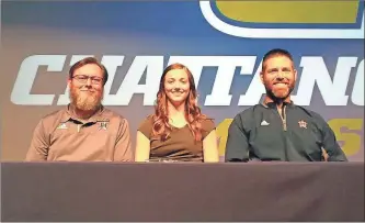  ?? / Scott Herpst ?? Heritage track coaches Kenny Nave and David Gibson were on hand to watch hurdler Madelyn Thompson sign to continue her track career at nearby Chattanoog­a.