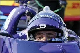  ?? DARRON CUMMINGS — THE ASSOCIATED PRESS FILE ?? In this May 14, 2021, file photo, Jimmie Johnson climbs out of his car following practice for the IndyCar auto race at Indianapol­is Motor Speedway in Indianapol­is. When a pair of poor finishes cost Alex Palou the IndyCar points lead, the second-year driver found teammate Johnson for a pair of pep talks. Johnson may be an IndyCar rookie on the track, but the intangible­s he brings to Chip Ganassi Racing as a seven-time NASCAR champion are invaluable.