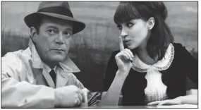  ??  ?? Detective Lemmy Caution (American émigre Eddie Constantin­e) is cautioned by Natacha von Braun (Anna Karina) in Jean-Luc Godard’s science fiction film noir Alphaville (1965).