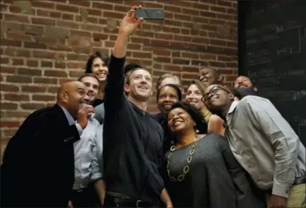  ?? THE ASSOCIATED PRESS ?? Facebook CEO Mark Zuckerberg takes a selfie with a group of entreprene­urs and innovators after taking part in a roundtable discussion at Cortex Innovation Community technology hub Thursday in St. Louis. Zuckerberg was in St. Louis to announce a program...