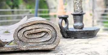  ?? PHOTOS: SALFORD CITY COUNCIL ?? Sculptures of a local newspaper with news about the canal and a miner’s candle, to help visitors appreciate the history of Worsley Delph.