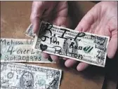  ??  ?? SHERRI NEWMAN and employees took the dollars off the walls, but she kept some, including the one commemorat­ing the death of her father.