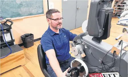  ?? ANDREW WATERMAN/THE TELEGRAM ?? Kevin Power, an associate professor in the school of human kinetics and recreation at Memorial University, uses arm cycling to study the relationsh­ip between the upper and lower body.