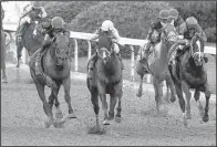  ?? Arkansas Democrat-Gazette/MITCHELL PE MASILUN ?? Classic Empire, ridden by Julien Leparoux (center), passes the field down the stretch to win the Arkansas Derby at Oaklawn Park in Hot Springs on Saturday.