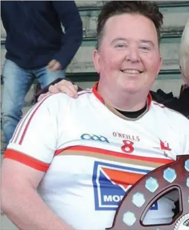  ??  ?? Winning captain Paul Martin is presented with the Masters Shield by Margaret Mulholland, wife of the late Patsy