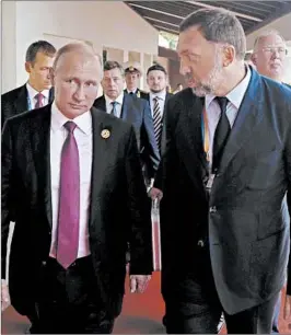  ?? MIKHAIL KLIMENTYEV/AP 2017 ?? Russian President Vladimir Putin, left, and metals magnate Oleg Deripaska, right, at a business conference in Vietnam last year. The U.S. sanctioned Deripaska on Friday.