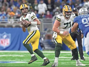  ?? AP ?? Packers rookie Josh Myers protects quarterbac­k Aaron Rodgers after the center returned to the starting lineup from a two-month layoff from knee surgery.