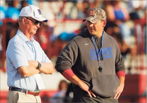  ?? John Munson / Associated Press ?? New York Giants coach Joe Judge, right, looks toward team president John Mara during training camp on July 31 in Newark, N.J. The low point in New York Giants co-owner Mara’s more than 30-year associatio­n with the franchise was seeing the team’s struggles in a four-win season that led to the retirement of general manager Dave Gettleman and the firing of Judge.