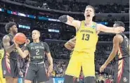  ?? HARRY HOW/GETTY IMAGES ?? Michigan’s Moritz Wagner celebrates a second-half basket against FSU in the Elite Eight on Saturday night.