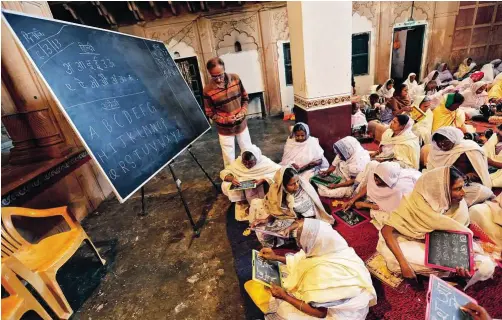  ??  ?? Empowered by education: Charities in Vrindavan teach widows English, Hindi and Bengali