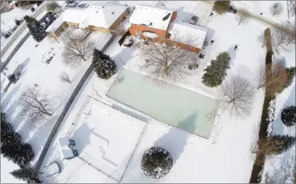  ?? Brown Family/Iron Sleek via AP ?? This Feb. 13, 2015 aerial drone photo provided by Iron Sleek shows the Brown family’s backyard ice rink in Toronto.