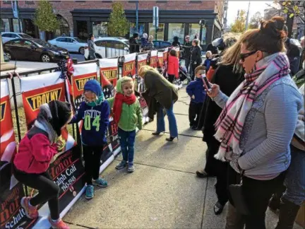  ?? RECORD FILE PHOTO ?? Alicia Germano, right, snaps a picture of nieces, from left, Samantha, Gabby and Lauren Germano by a banner honoring the military serve of her uncle, Ralph Coli, prior to a Nov. 11, 2016, ceremony in front of the 4th Avenue entrance to the U.S. post...