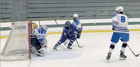  ?? NICK MALLARD / SENTINEL & ENTERPRISE ?? Lunenburg/Ayer Shirley's Nathan Handy slips a shot past Leominster goalie Ryan Melanson during Saturday night's game.