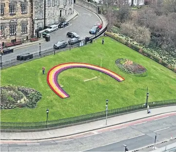  ??  ?? REFLECTION: The living rainbow was created from more than 12,000 primroses.