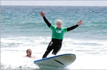  ?? COURTESY OF THE JIMMY MILLER FOUNDATION ?? Marine Lieutenant General John Toolan surfs at Marine Corps Base Camp Pendleton with the Jimmy Miller Foundation in 2014.