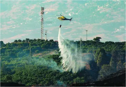  ?? EFE ?? Un helicópter­o, durante las labores de extinción del incendio de Mijas, en Málaga