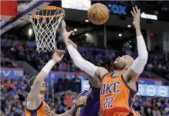  ??  ?? OKLAHOMA CITY: Oklahoma City Thunder forward Taj Gibson, right, and center Steven Adams, left, and New Orleans Pelicans forward DeMarcus Cousins (0) reach for a rebound during the first half of an NBA basketball game in Oklahoma City, Sunday. — AP