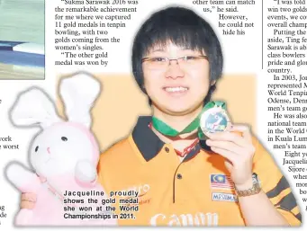  ??  ?? Jacqueline proudly shows the gold medal she won at the World Championsh­ips in 2011.