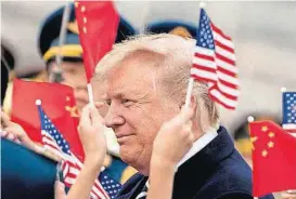  ?? [AP PHOTO] ?? Children wave U.S. and Chinese flags as President Donald Trump arrives at Beijing Airport on Wednesday in Beijing, China. Trump is on a five-country trip through Asia, traveling to Japan, South Korea, China, Vietnam and the Philippine­s.