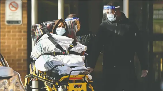  ?? NATHAN DENETTE/THE CANADIAN PRESS ?? Paramedics take away a patient from Revera Westside Long Term Care Home, the site of an outbreak, in December. Of those who died of COVID in Canada, 73% were in care homes.