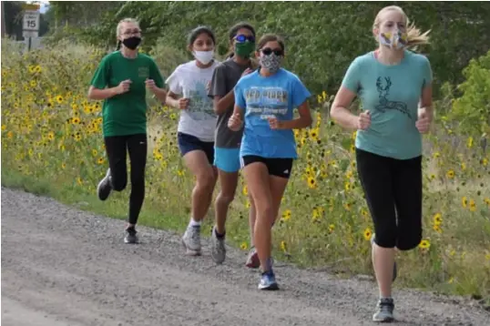  ??  ?? Right to left, Moriarty cross country runners Tessa Buck, Evalinn Volk, sisters Jessica and Sophia Martinez, and Kaisa Baca during their five-mile practice run. Photo by Ger Demarest.