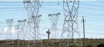  ??  ?? Power lines feed electricit­y to the national grid from Koeberg Nuclear Power Station. (Photo by: Education Images/UIG via Getty Images)