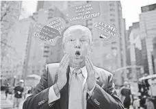  ??  ?? A protester wears a Trump mask in New York on Saturday. KENA BETANCUR, AFP/GETTY IMAGES