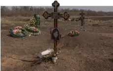  ?? ?? The graves of the victims of the Russian strike that hit a cafe last year, at a cemetery in the village of Groza, Kharkiv region, amid the Russian invasion of Ukraine.