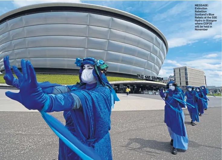  ??  ?? MESSAGE: Extinction Rebellion Scotland’s Blue Rebels at the SSE Hydro in Glasgow where COP26 will be held in November